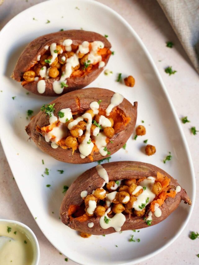 3-baked-sweet-potatoes-on-a-white-plate-with-roasted-chickpeas-and-white-sauce-from-above